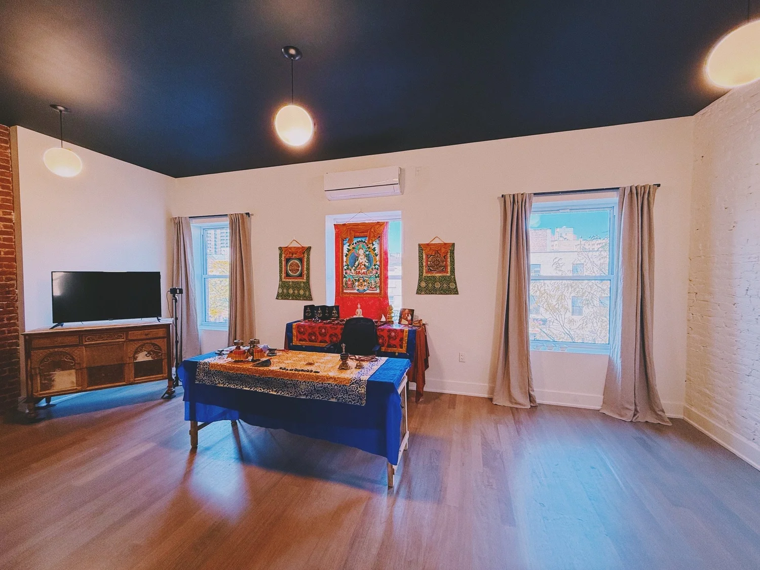 The top-floor loft with exposed brick fireplaces and tall windows