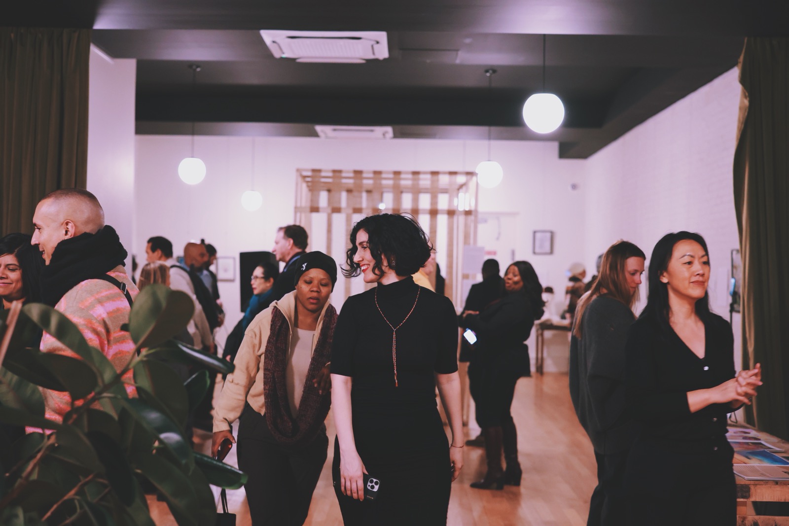 Guests arriving and talking in the open gallery